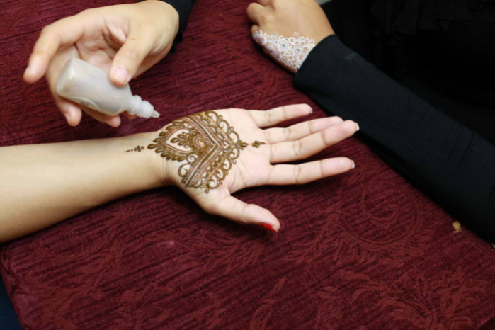 Adding glitter to the design.